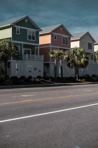 white and brown house beside green palm tree during daytime